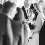 A bride and groom exchange heartfelt glances during their Savage Mill wedding ceremony.