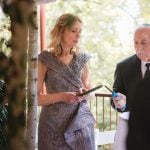 A man is reading wedding vows during a ceremony at Savage Mill.