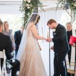 A couple at Savage Mill exchange rings during their wedding ceremony.