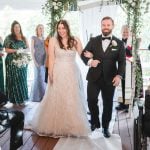 A bride and groom walking down the aisle at their Savage Mill wedding ceremony.