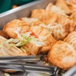 A tray of food on a table with a fork at Savage Mill, Wedding.