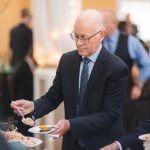 A man serving food to a group of people at a wedding reception.