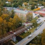 An aerial view of a train crossing Savage Mill, showcasing intricate details.