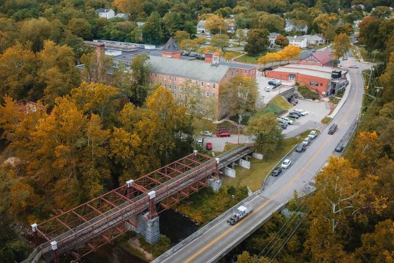 An aerial view of a train crossing Savage Mill, showcasing intricate details.