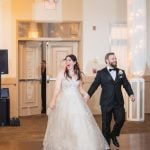 A bride and groom dancing on the dance floor at their wedding reception at Savage Mill.