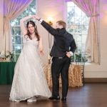 A bride and groom sharing their first dance at a wedding reception.