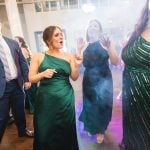 A group of bridesmaids dancing at a wedding reception.