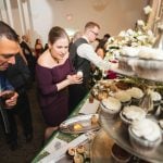 A man and woman looking at cupcakes at a wedding reception held at Savage Mill.