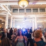 A group of people dancing at a wedding reception held at Savage Mill.