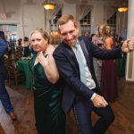 A man and woman gracefully dancing at a wedding reception held at Savage Mill.