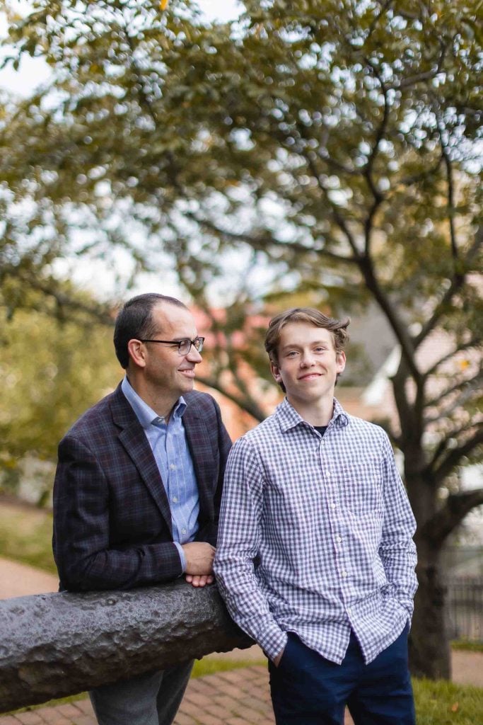 Two men in Downtown Annapolis, leaning on a railing in a park.