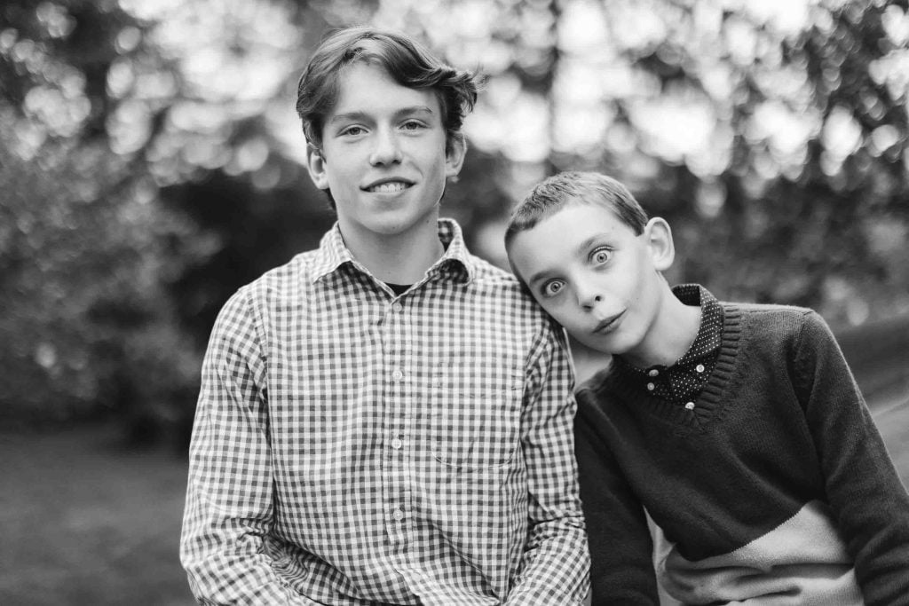 A black and white photo of two boys sitting on a bench in downtown Annapolis.