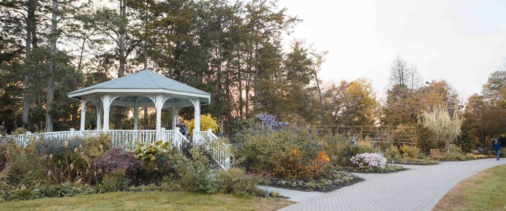 A gazebo situated in the middle of a beautiful garden in Alexandria, Virginia's Green Spring Gardens.