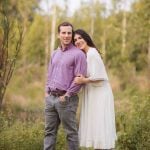 An engaged couple posing for a photo in the enchanting Patuxent Research Refuge, bathed in the warm hues of a sunset.