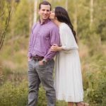 A couple kisses in the woods during their engagement session at Patuxent Research Refuge in Maryland, capturing stunning engagement photos.