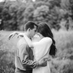 A black and white photo of a couple embracing in Patuxent Research Refuge.