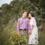 An engaged couple having their engagement photos taken in a field of tall grasses at Patuxent Research Refuge in Maryland.