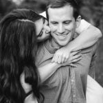 A black and white photo of a man hugging a woman in Patuxent Research Refuge, Maryland.