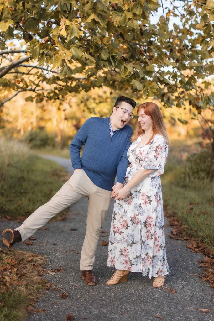 An engaged couple standing at Patuxent Research Refuge in the fall, capturing beautiful engagement portraits.