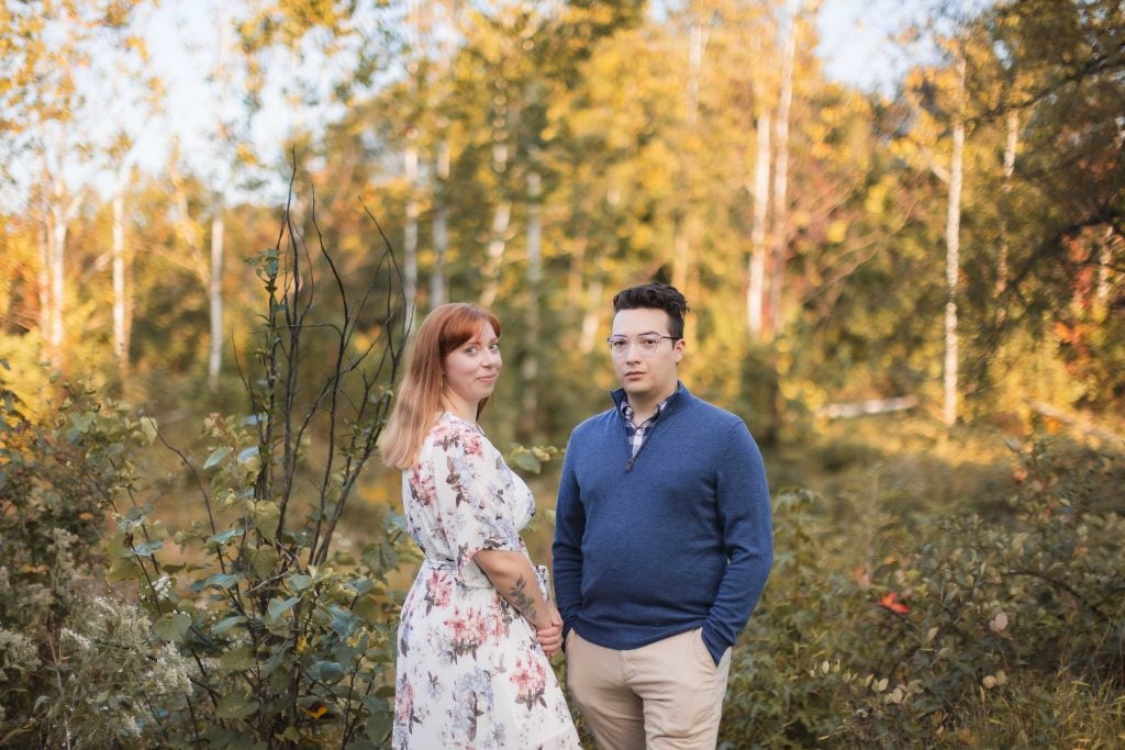 An engagement couple posing for portraits in the woods at Patuxent Research Refuge.