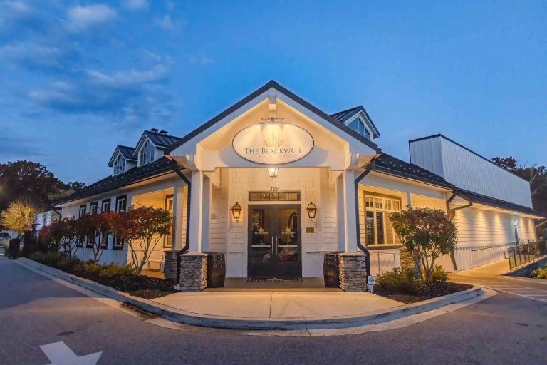 The captivating entrance to a restaurant at dusk offers intricate details that evoke an enchanting ambiance perfect for a dreamy wedding celebration.