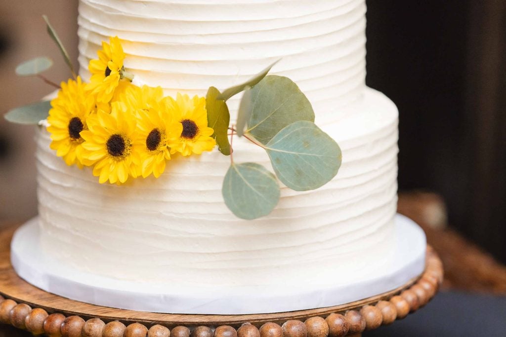 Wedding cake with sunflowers and eucalyptus leaves.