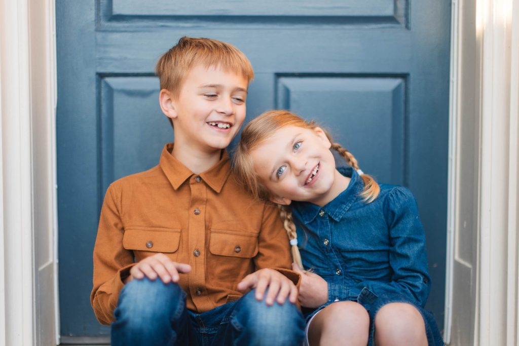 Two children sitting on the steps of Belair Mansion in Bowie, Maryland.