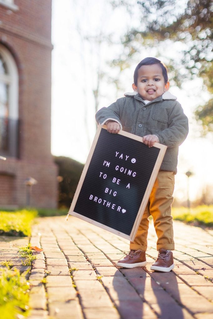 a boy holding a sign