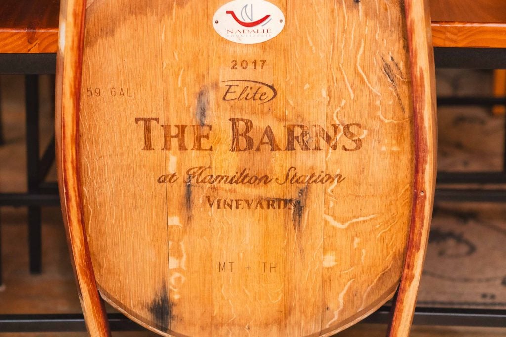 A wine barrel labeled "59 Gal 2017 Elite The Barns at Hamilton Station Vineyards" with a Nadalié USA logo at the top, perfect for adding rustic charm to wedding details.